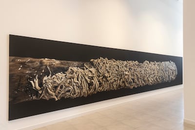Abdulla P A’s monumental oil painting considers what happens to homes when they are abandoned and gradually reclaimed by nature. Antonie Robertson / The National
