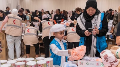Volunteers pack aid for Palestinians in Gaza at Al Rimal Hall in Dubai on Saturday. All photos: Antonie Robertson / The National