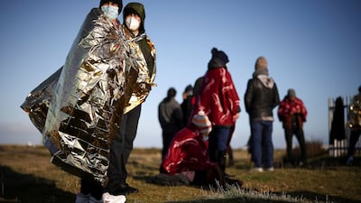 Migrants on a beach in Dungeness, Kent, after crossing the English Channel. Reuters