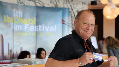 The National’s Charles Whebell flashes the card that identifies him as an official volunteer with the Abu Dhabi Film Festival at the Fairmont Bab Al Bahr. His duties included packing goodie bags and surveying fans.