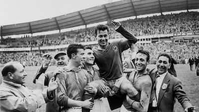 (FILES) French forward Just Fontaine (C) celebrates and is lifted by teammates Yvon Douis, Andre Lerond and Jean Vincent, after he scored four goals against Germany during a third place match of the 1958 Swedish World Cup, in Goteborg on June 28, 1958. - Just Fontaine, a recordman of 13 goals in the 1958 World Cup in Sweden, died on March 1, 2023 at 89-years-old, announced his family. (Photo by STAFF / AFP)