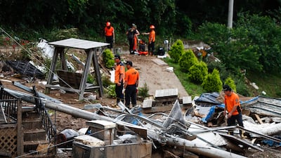 Emergency workers conduct a search after landslides and heavy rain in Yecheon-gun, South Korea's Gyeongsangbuk-do province. EPA