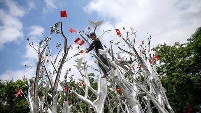 A man installs artwork at a park in Hanoi, Vietnam. EPA