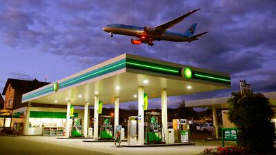 An aircraft flies over a BP petrol station. The oil major has seen profits rise. Arnd Wiegmann/Reuters