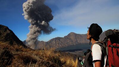 An Indonesian man looks on as volcanic ash is spewed from Mount Baru Jari on November 1 as seen from from Mount Rinjani in Lombok. It was Mount Rinjani's turn to erupt today. Pikong / AFP Photo