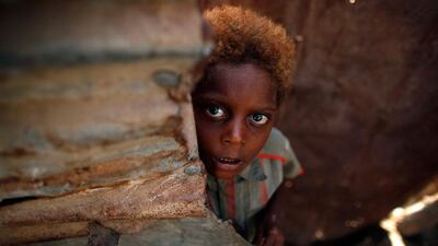 A boy stands at the door of his family's hut in Yemen's western port city of Houdieda.