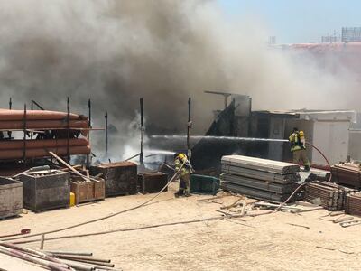 Civil Defence teams tackle the blaze on the breakwater. Courtesy Abu Dhabi Police