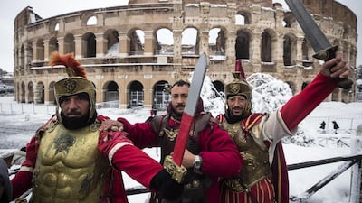 Men pose centurions in front of the Colosseum during a snowfall in Rome, Italy. The country is looking to attract wealthy foreigners. Angelo Carconi/EPA