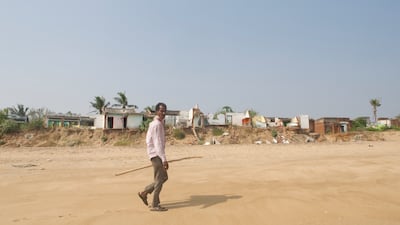 Bhima Rao, 45, is walking past the rows of houses that hold their foundations to the last remaining bits of earth along India's eastern coast in the Bay of Bengal.