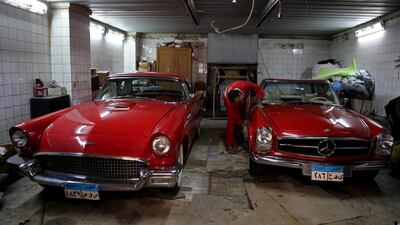 A 1955 Ford standard Bird and a 1968 Mercedes are worked on at a car repair shop, which used to service the monarch's vehicles.