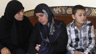 The mother, centre, of Lebanese soldier Abbas Medlej, who was beheaded by Islamic State of Iraq and the Levant militants in Arsal, mourns during his funeral in his hometown in Ansar, south Baalbak, on Sunday. Ahmad Shalha / Reuters