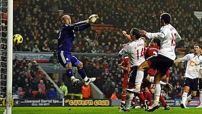 Bolton Wanderers' Kevin Davies, second from left, scores the opening goal past Liverpool's Spanish goalkeeper Pepe Reina.
