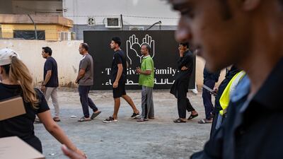 A worker receives his iftar meal. Antonie Robertson / The National