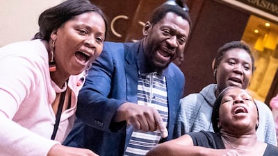 Supporters of the president-elect Emmerson Mnangagwa celebrate after the announcement of his re-election in Harare. AFP/MARCO LONGARI