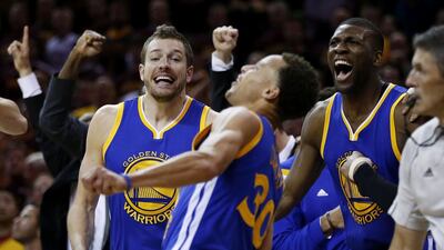 Stephen Curry #30 celebrates with David Lee #10 and Festus Ezeli #31 of the Golden State Warriors as the defeated the Cleveland Cavaliers 105 to 97 during Game Six of the 2015 NBA Finals at Quicken Loans Arena on June 16, 2015 in Cleveland, Ohio. Ezra Shaw/Getty Images