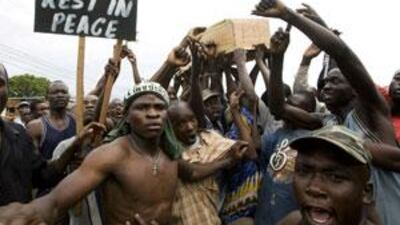 Supporters of Kenya's opposition leader, and prime minister, Raila Odinga carry out a mock burial ceremony of the Kenyan president Mwai Kibaki during a demonstration in Kisumu in January 2008. Election-related violence was blamed for 1,300 deaths, which some fear could happen again.