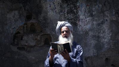 A Palestinian man reads the Koran during the holy month of Ramadan in Gaza City during the COVID-19 coronavirus pandemic. AFP