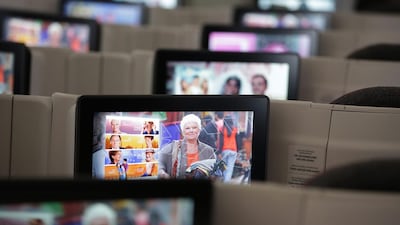 The days when flying meant an opportunity to gaze at the clouds out the window or finish a book, are long gone, and many travellers – particularly younger ones – are used to whiling away the hours on an iPad. Jason Alden / Bloomberg