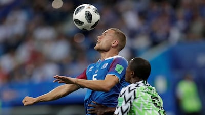 Sverrir Ingi Ingason wins a head in front of Nigeria's Odion Ighalo. Ueslei Marcelino / Reuters