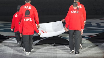 An athlete raises the Special Olympics flag during the opening ceremony of the Special Olympics IX MENA Games Abu Dhabi 2018, at the Abu Dhabi National Exhibition Centre (ADNEC). Hamad Al Mansouri / the Crown Prince Court