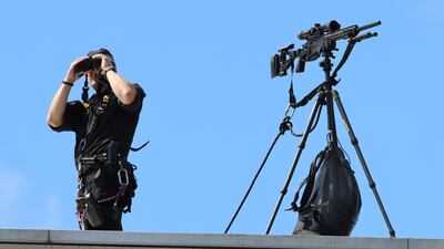 A police marksman keeps watch from the Scottish Parliament rooftop. Getty
