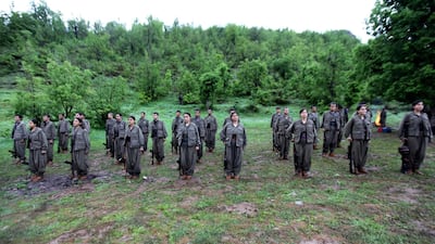 Armed Kurdish fighters from the PKK stand at attention after arriving in the Heror area, north-east of Duhok in May 2013. AP