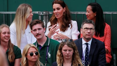 Kate Middleton, Duchess of Cambridge, sits with former British tennis player Anne Keothavong, right, and current player Katie Boulter during the first-round match between Britain's Harriet Dart and Christina McHale of the US. Reuters