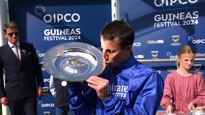 Jockey William Buick celebrates with the trophy after winning the 2000 Guineas Stakes for Godolphin. PA