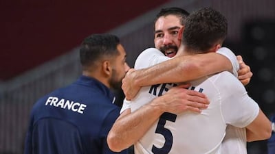 France's centre-back Nikola Karabatic celebrates with a teammate.