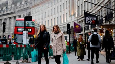 Pedestrians walk through a quiet central London. AFP