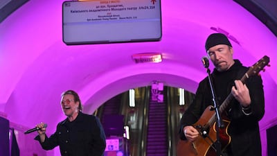 Bono and the Edge perform in the subway station which is also used as a bomb shelter. AFP
