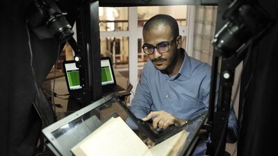 Adel Nabawy scans books from the collection. David Degner for The National