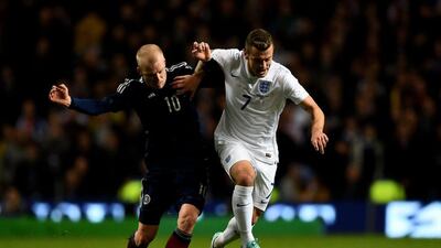 Jack Wilshere of England is challenged by Steven Naismith of Scotland during their International friendly on Tuesday. Shaun Botterill / Getty Images / November 18, 2014