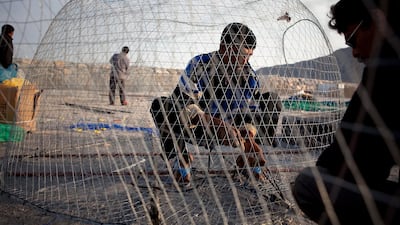 Fishermen assemble baskets in Khasab, a small port town in Musandam. Silvia Razgova / The National