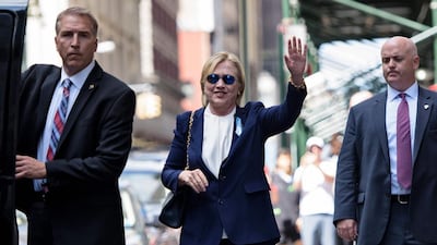 US Democratic presidential nominee Hillary Clinton waves to the press as she leaves her daughter's apartment building after resting on September 11, 2016 in New York. Clinton departed from a remembrance ceremony on the 15th anniversary of the 9/11 attacks after feeling 'overheated', but was later doing 'much better', her campaign said. Brendan Smialowski / AFP