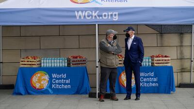 Mr Biden talks with José Andrés, of the Think Food Group, at PGE Narodowy Stadium. AP