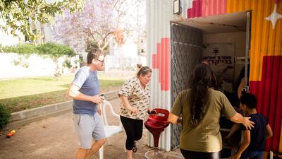 Israelis run for a shelter as they warnings of incoming rockets from the Gaza Strip on May 17, in Ashdod, Israel. Getty