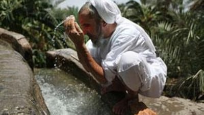 Sulaiman bin Nasser bin Abdullah al Abry, the wakeel of the town of Misfat in Oman, washes himself in the falaj he helps maintain before going to pray. In the UAE, water consumption per person is among the highest in the world.