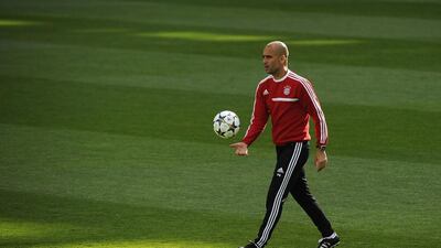 Bayern Munich’s Spanish head coach Pep Guardiola walks on the pitch during a training session at the Santiago Bernabeu stadium in Madrid on April 22, 2014 on the eve of their UEFA Champions League semifinal first leg football match Real Madrid CF vs Bayern Munich. AFP PHOTO/ PEDRO ARMESTRE