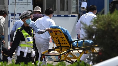 Workers bring a gurney into hospital. AFP