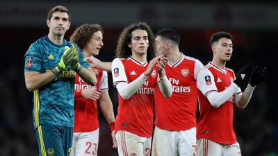 Arsenal players celebrate after winning the FA Cup third round match against Leeds. AP
