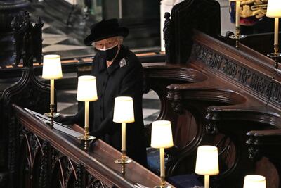 Queen Elizabeth II watches as pallbearers carry the coffin of Prince Philip, Duke Of Edinburgh into St George’s Chapel. Getty Images
