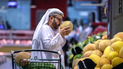 A shopper checks the freshness of a melon on display at LuLu Hypermarket, Al Forsan Central Mall, Abu Dhabi. Victor Besa / The National
