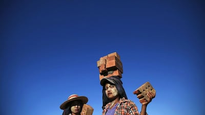 A construction worker carries bricks on her head near the country's parliament building in Naypyitaw on November 11, 2014. Yangon lost its status as Myanmar's capital in 2005, after the former military junta carved a new seat of government from a parched wilderness some 380km to the north and called it Naypyitaw ("Abode of Kings"). This week, Naypyitaw will have its coming out party as world leaders, including United States president Barack Obama, Japanese prime minister Shinzo Abe and Chinese prime minister Li Keqiang, attend meetings organised around a summit of the Association of Southeast Asian Nations (ASEAN). Damir Sagolj / Reuters
