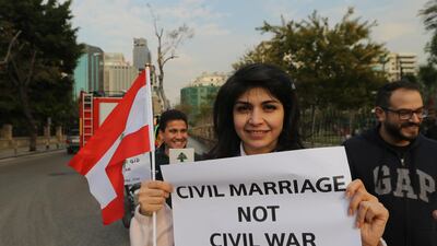 Lebanese activists carry placards during a protest demanding civil marriage law in front the Interior Ministry in Beirut, Lebanon 23 February, 2019. EPA