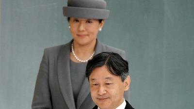 Japanese Emperor Naruhito, accompanied by Empress Masako, walks to deliver his remarks during a memorial ceremony for the war dead at Nippon Budokan Martial Arts Hall in Tokyo. AP
