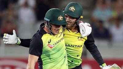 Australia's Alex Carey, right, and Aaron Finch celebrate their side's win over New Zealand. Michael Bradley / AFP Photo