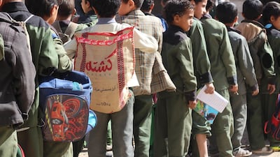 A child at a school in Sanaa carries a rice sack to function as a back-pack.Ali Alsonidar