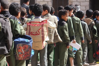A child at a school in Sanaa carries a rice sack to function as a back-pack.Ali Alsonidar
