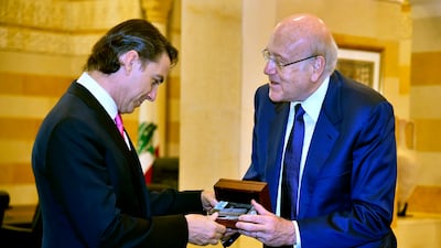Lebanese Prime Minister Najib Mikati, right, presents a gift to US Envoy for Energy Affairs Amos Hochstein in Beirut. AP